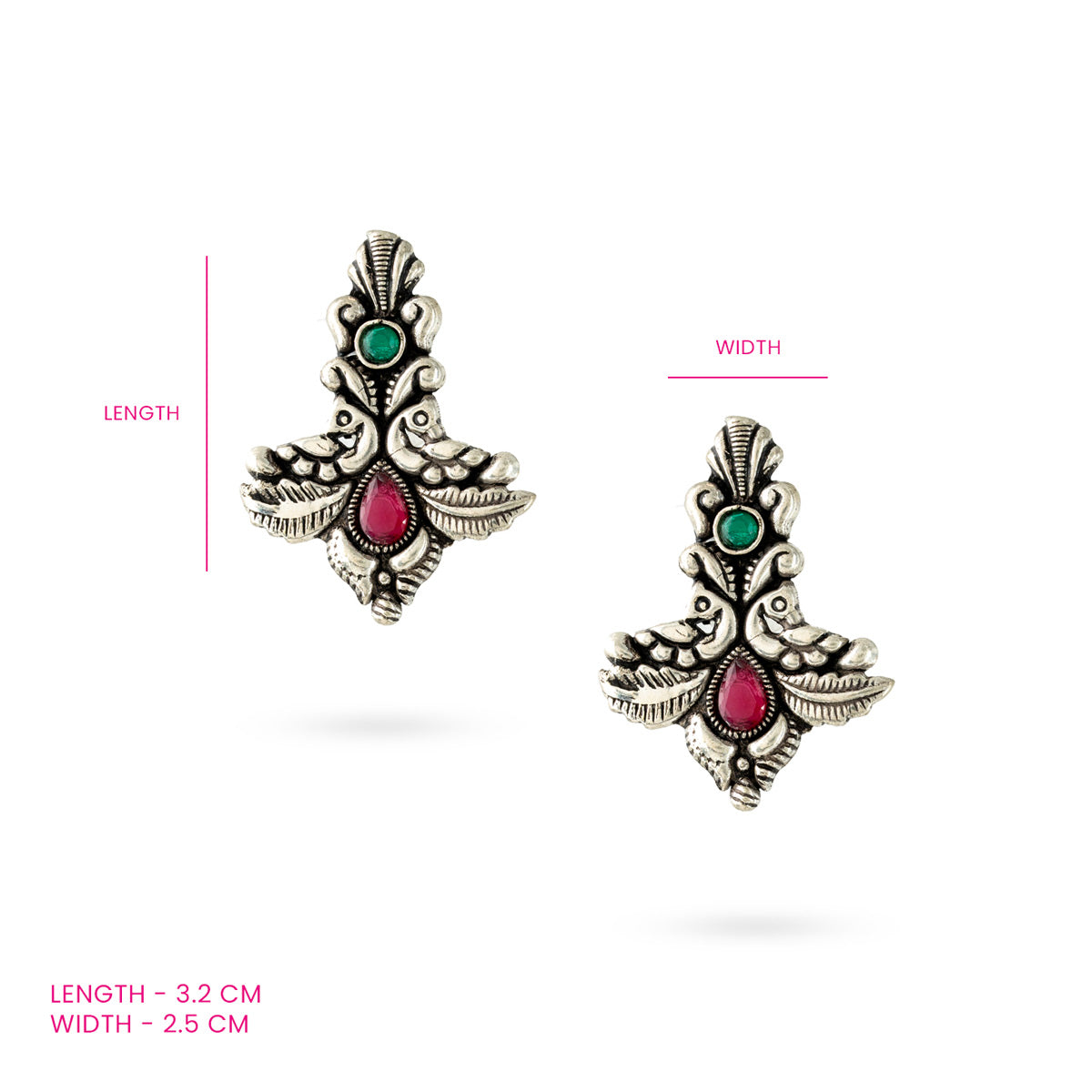 A pair of oxidized silver twin peacock earrings with intricate detailing and vibrant green and pink stones against a white background along with measurements.