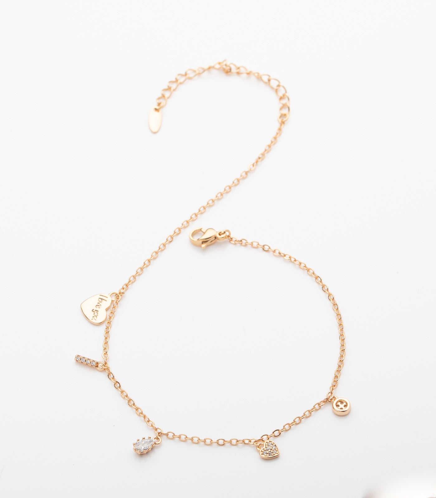 Rose gold bracelet with heart-shaped charm on a white background