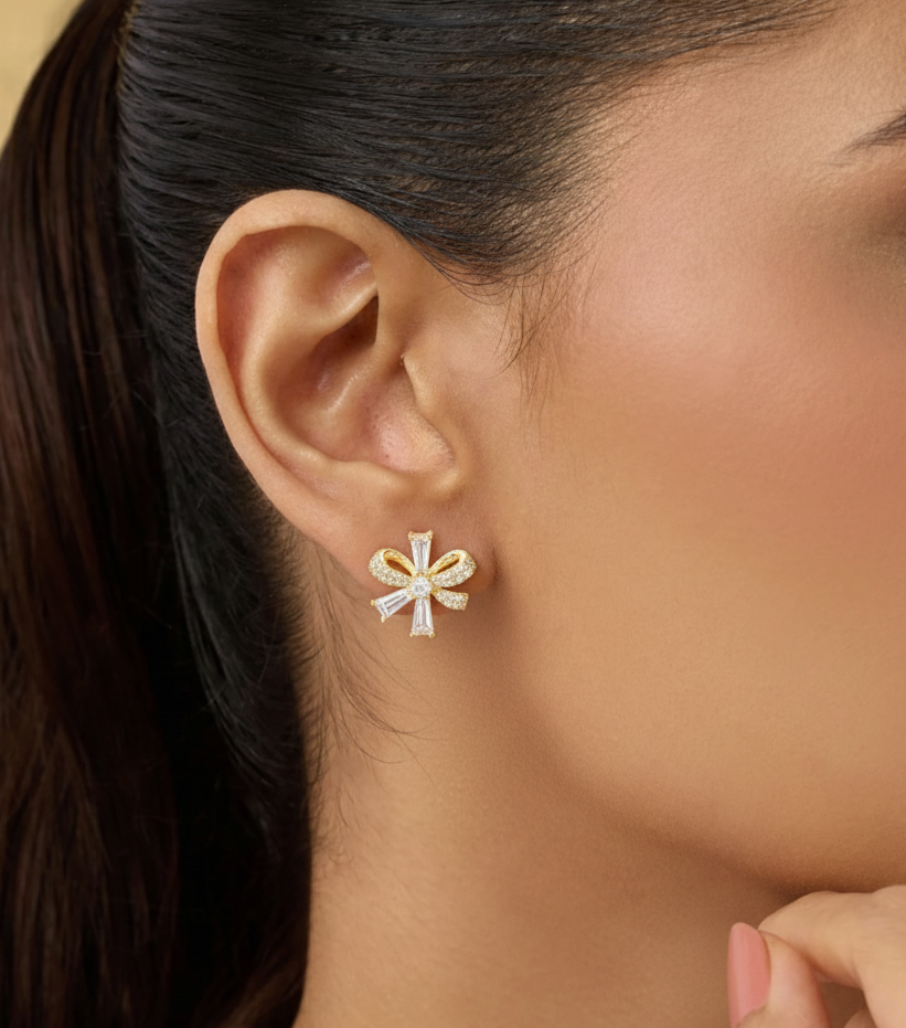 Close-up of a woman wearing a gold and white floral earring.