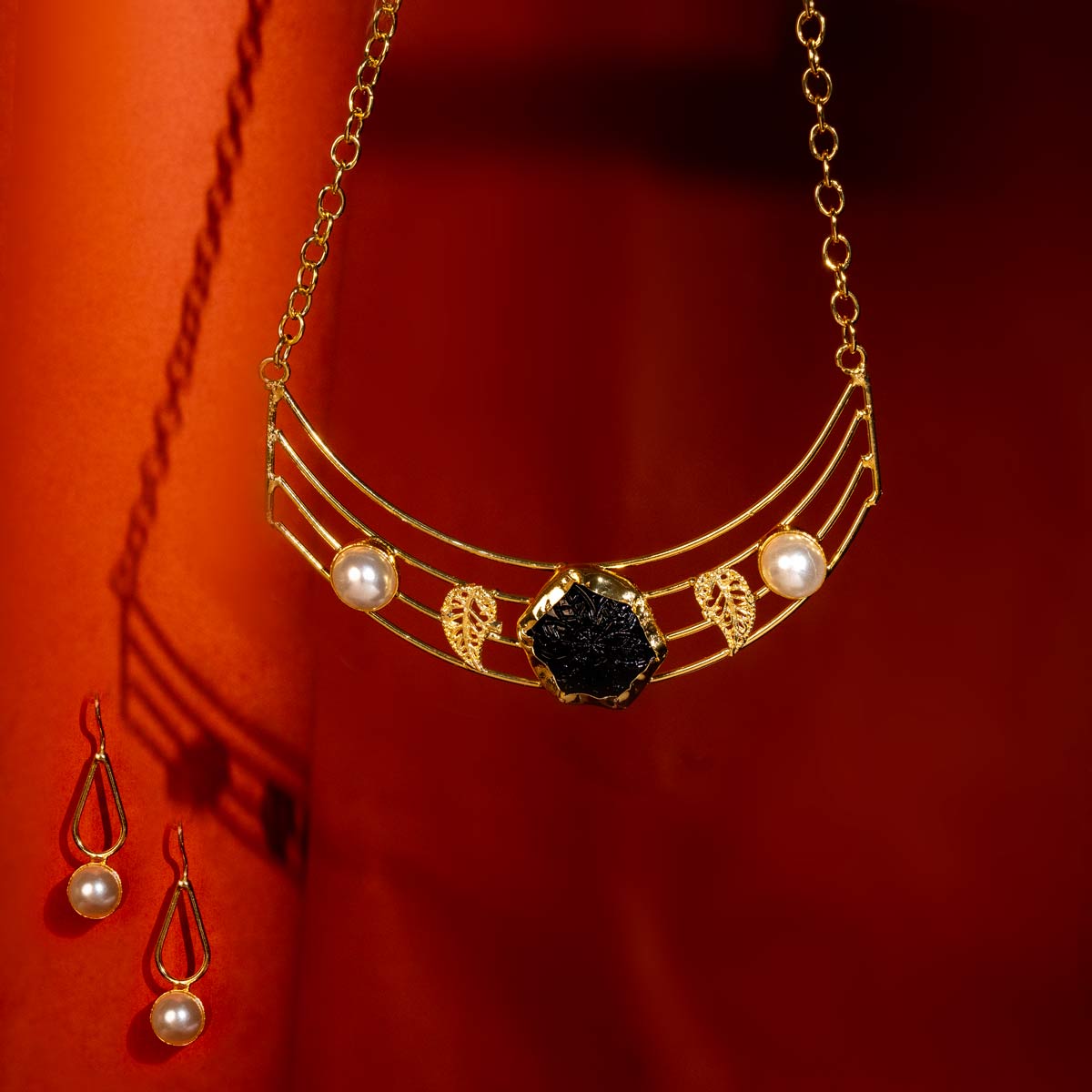 Golden Modern Necklace Set with Black Stone and Pearl Accents