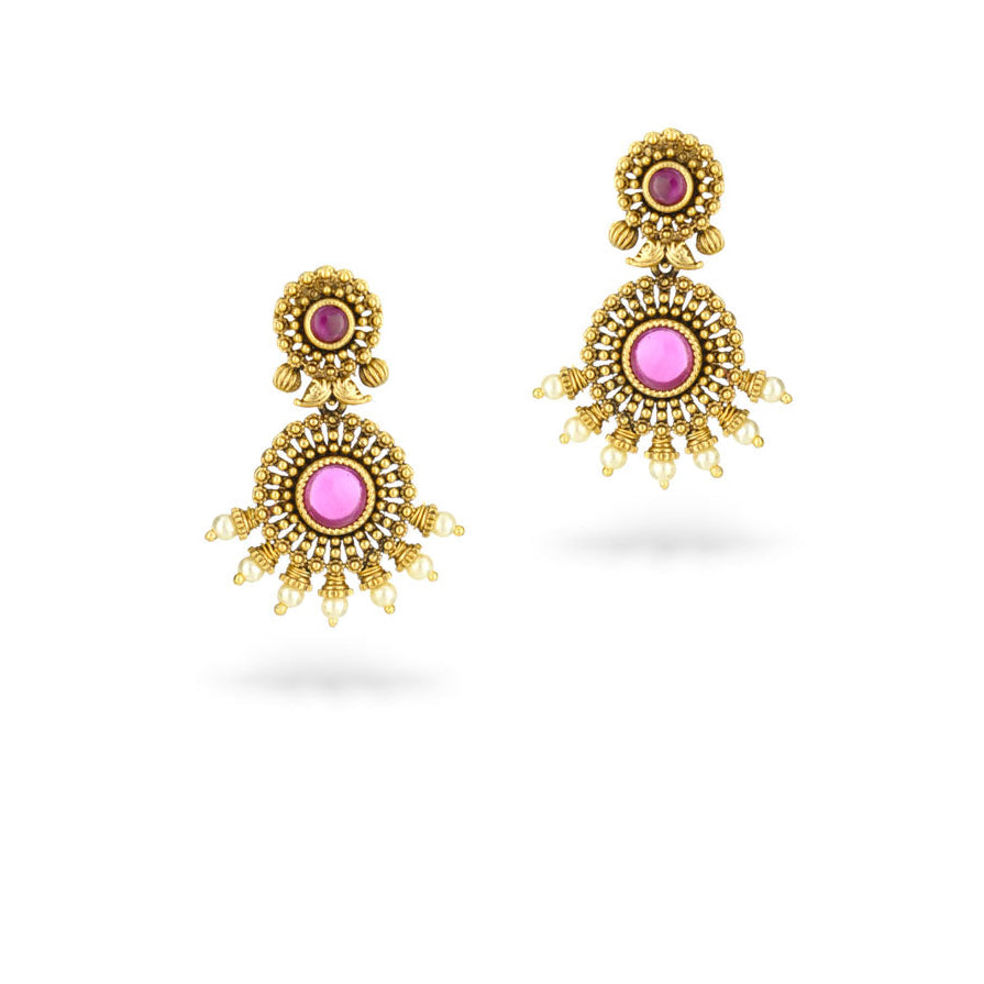 Pair of gold earrings with pink gemstones on a white background