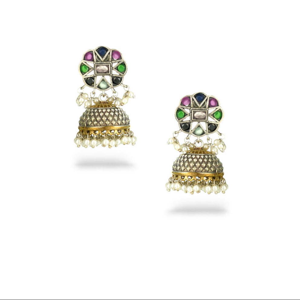 Pair of ornate earrings with gemstones on a white background